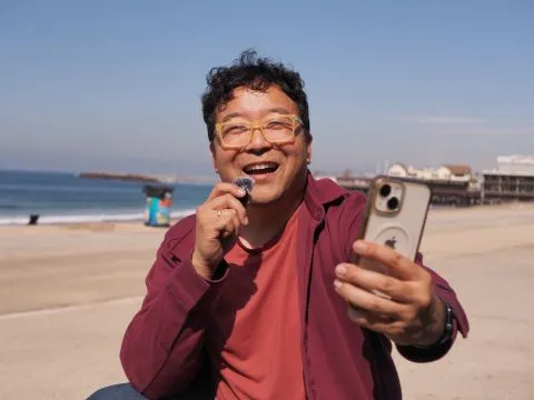 Ed filming a video at the beach